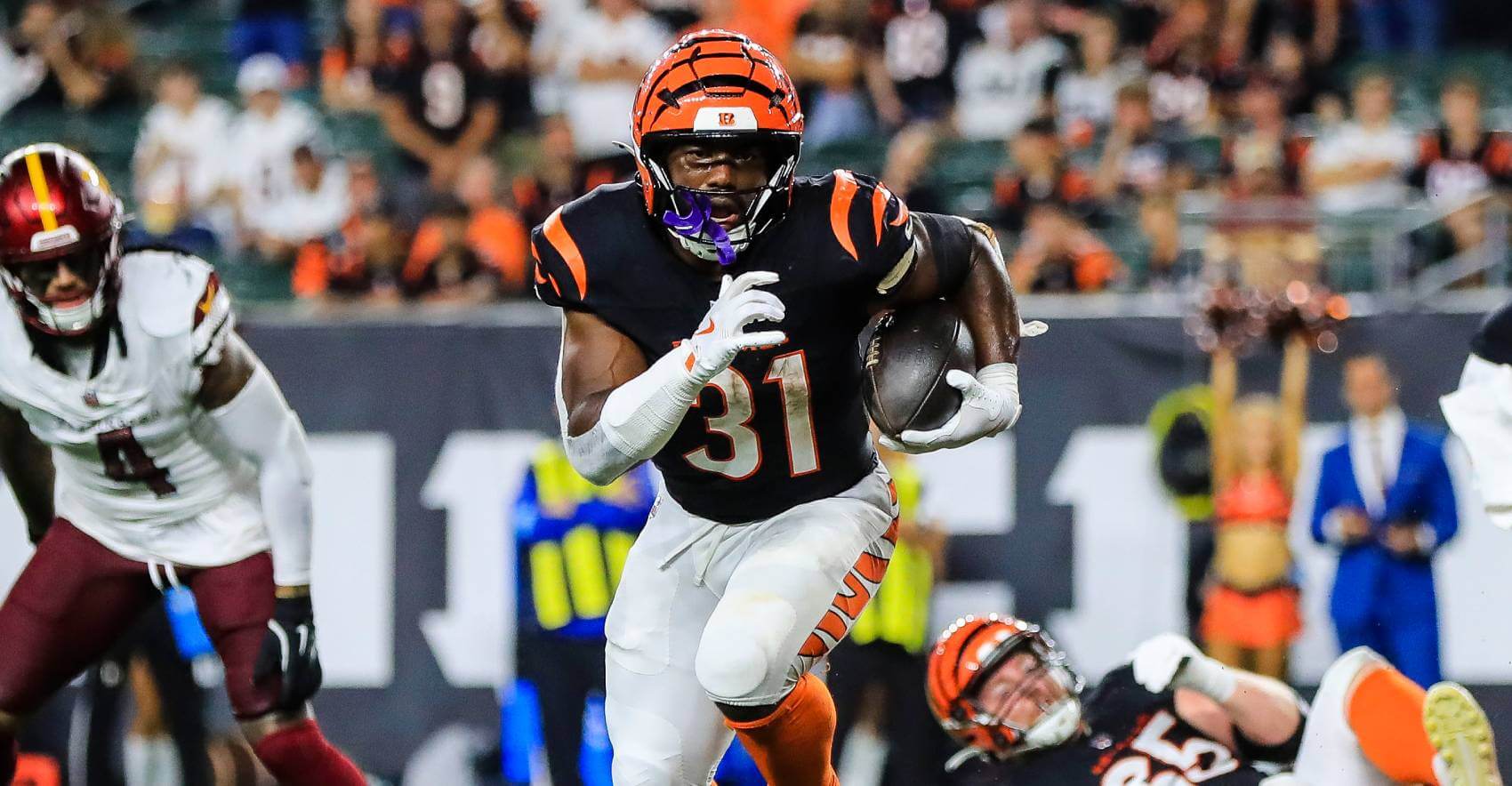 Cincinnati Bengals running back Zack Moss (31) runs with the ball for a touchdown against the Washington Commanders in the second half at Paycor Stadium.
