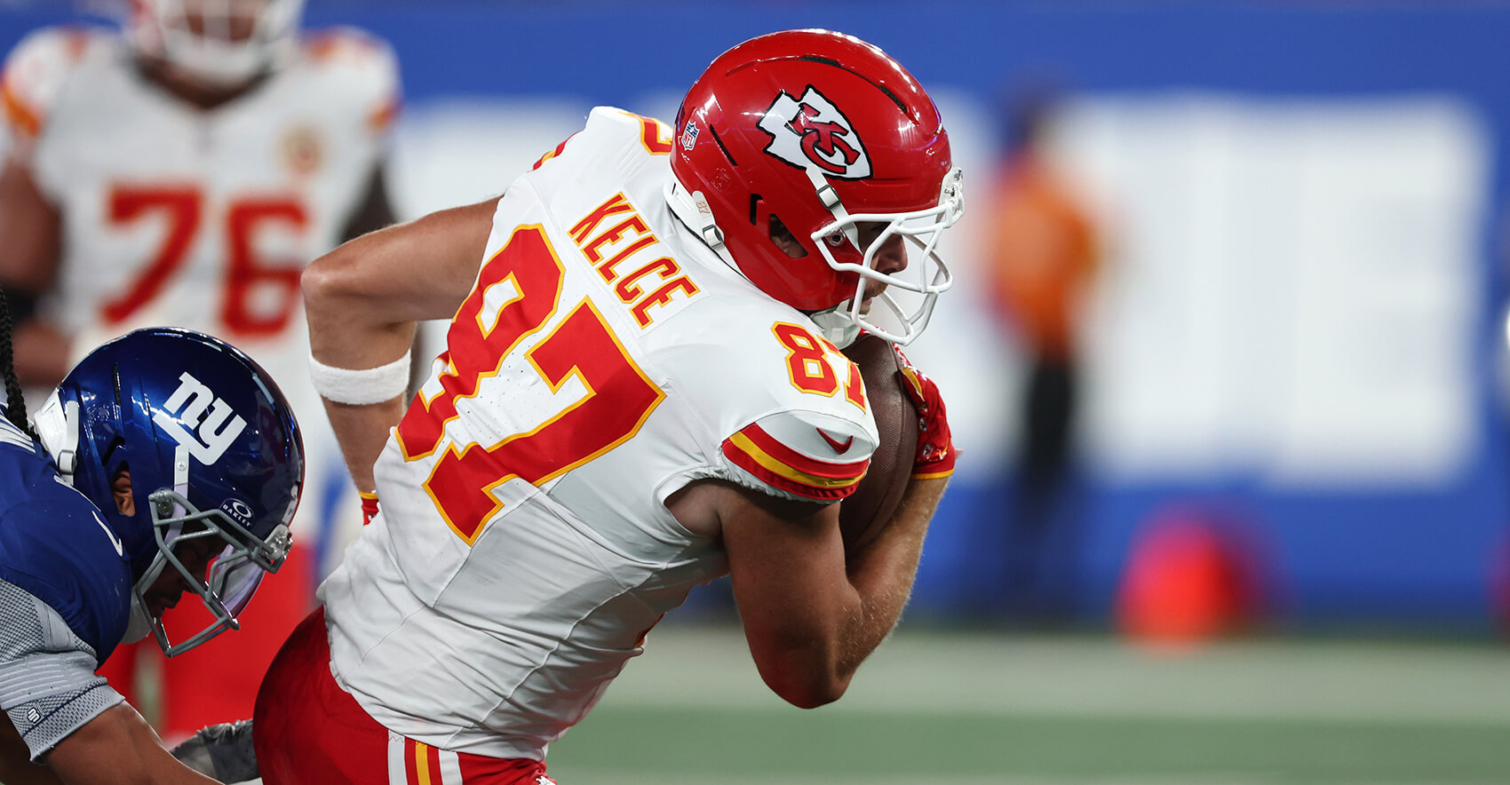 Sep 21, 2025; East Rutherford, New Jersey, USA; Kansas City Chiefs tight end Travis Kelce (87) runs against New York Giants safety Dane Belton (24) in the third quarter at MetLife Stadium. Mandatory Credit: Vincent Carchietta-Imagn Images