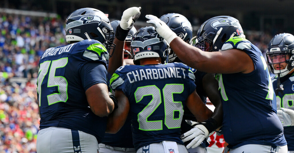 Sep 7, 2025; Seattle, Washington, USA; Seattle Seahawks running back Zach Charbonnet (26) celebrates with teammates after scoring a touchdown during the first half against San Francisco 49ers at Lumen Field. Mandatory Credit: Steven Bisig-Imagn Images