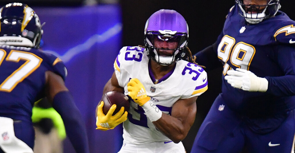 Oct 23, 2025; Inglewood, California, USA; Minnesota Vikings running back Aaron Jones Sr. (33) rushes the ball against the Los Angeles Chargers during the second half at SoFi Stadium. Mandatory Credit: Gary A. Vasquez-Imagn Images