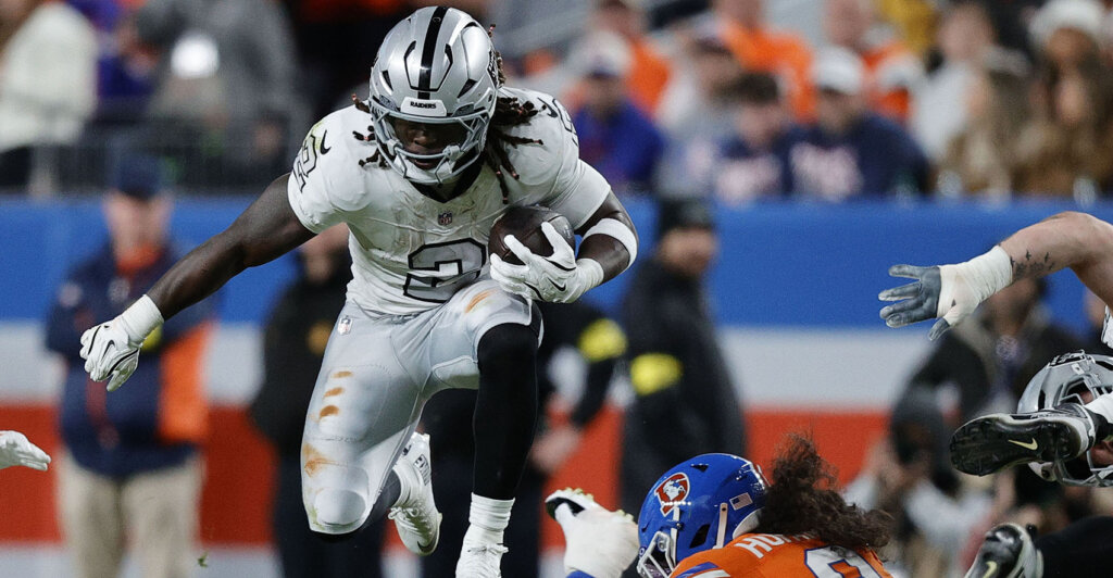 Nov 6, 2025; Denver, Colorado, USA; Las Vegas Raiders running back Ashton Jeanty (2) rushes the ball against the Denver Broncos during the first half at Empower Field at Mile High. Mandatory Credit: Isaiah J. Downing-Imagn Images