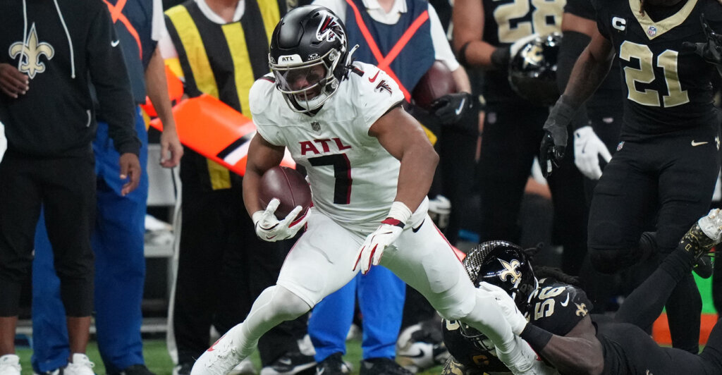 Nov 23, 2025; New Orleans, Louisiana, USA; Atlanta Falcons running back Bijan Robinson (7) looks to break the tackle attempt by New Orleans Saints linebacker Demario Davis (56) during the second half at Caesars Superdome. Mandatory Credit: Matthew Hinton-Imagn Images