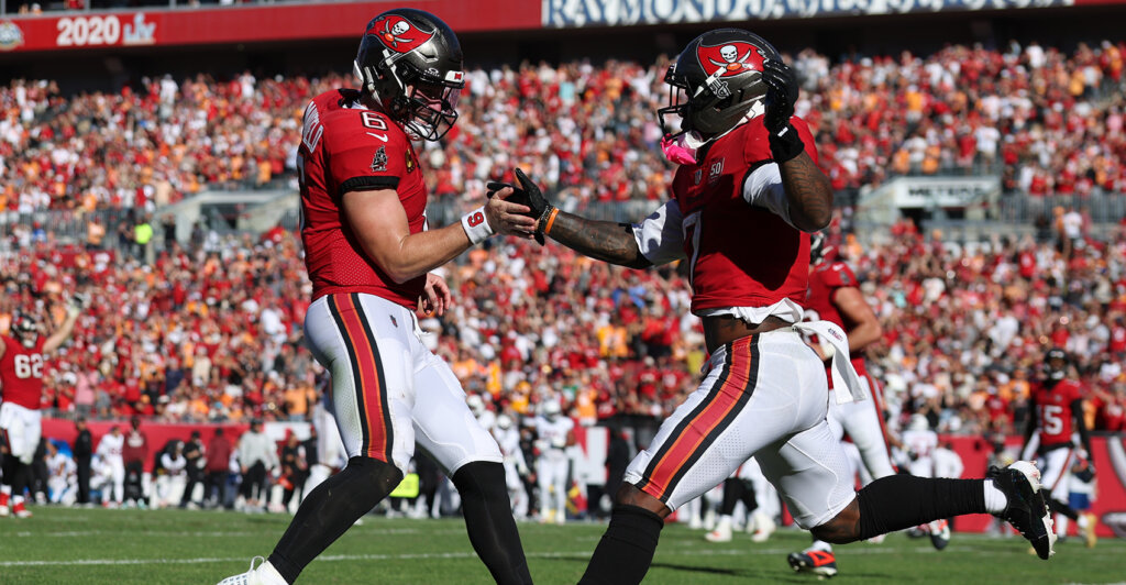 Nov 30, 2025; Tampa, Florida, USA; Tampa Bay Buccaneers running back Bucky Irving (7) celebrates with quarterback Baker Mayfield (6) after a touchdown during the second half against the Arizona Cardinals at Raymond James Stadium. Mandatory Credit: Nathan Ray Seebeck-Imagn Images