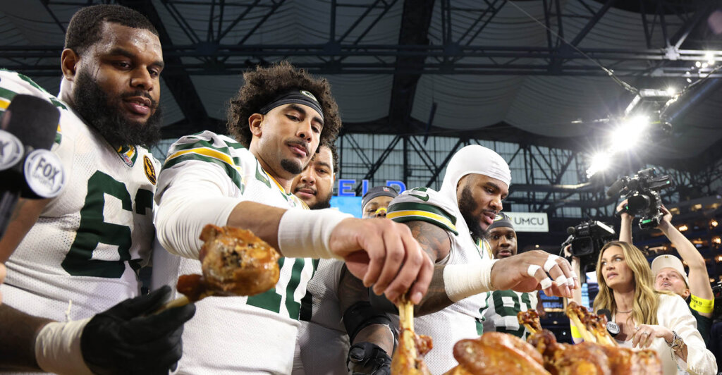 Nov 27, 2025; Detroit, Michigan, USA; Green Bay Packers quarterback Jordan Love (10) and Green Bay Packers defensive end Micah Parsons (1) eat turkey after defeating the Detroit Lions at Ford Field. Mandatory Credit: David Reginek-Imagn Images