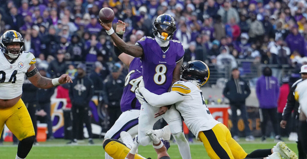 Dec 7, 2025; Baltimore, Maryland, USA; Baltimore Ravens quarterback Lamar Jackson (8) passes the ball while defended by Pittsburgh Steelers linebacker Alex Highsmith (56) and linebacker Nick Herbig (51) during the second half at M&T Bank Stadium. Mandatory Credit: Mitch Stringer-Imagn Images