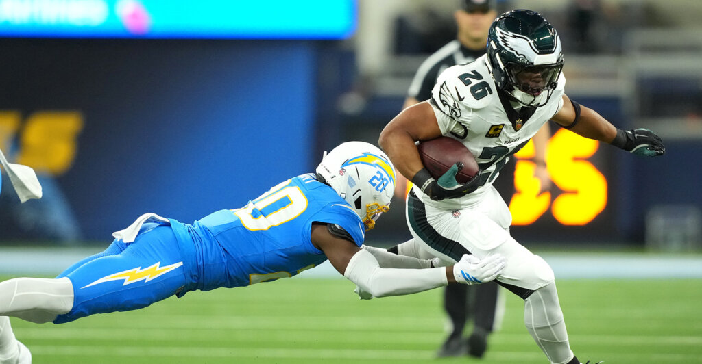 Dec 8, 2025; Inglewood, California, USA; Philadelphia Eagles running back Saquon Barkley (26) runs against Los Angeles Chargers cornerback Cam Hart (20) in the first half at SoFi Stadium. Mandatory Credit: Kirby Lee-Imagn Images