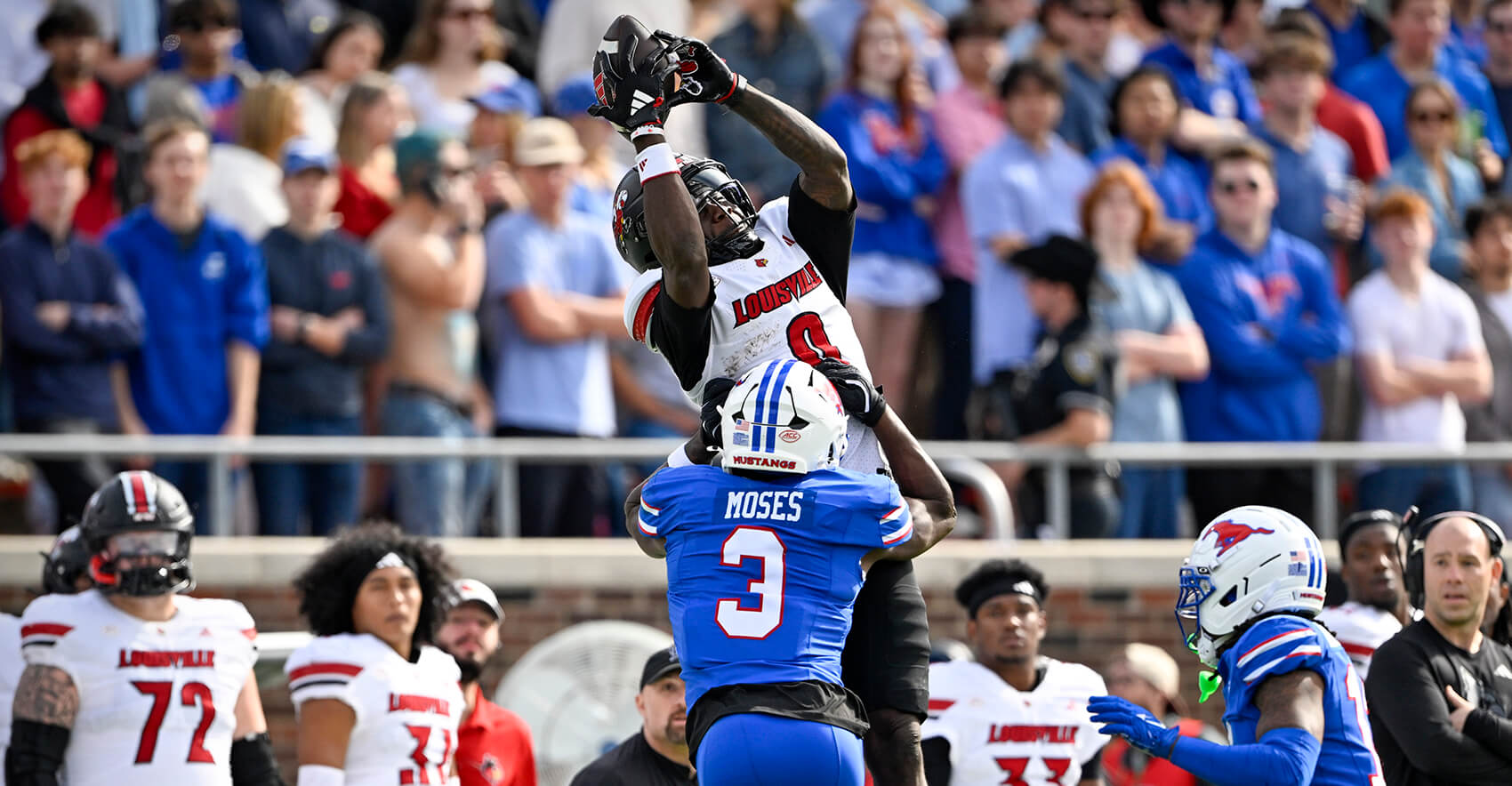 Nov 22, 2025; Dallas, Texas, USA; Louisville Cardinals wide receiver Chris Bell (0) catches a pass over SMU Mustangs safety Ahmaad Moses (3) during the first half at Gerald J. Ford Stadium. Mandatory Credit: Jerome Miron-Imagn Images