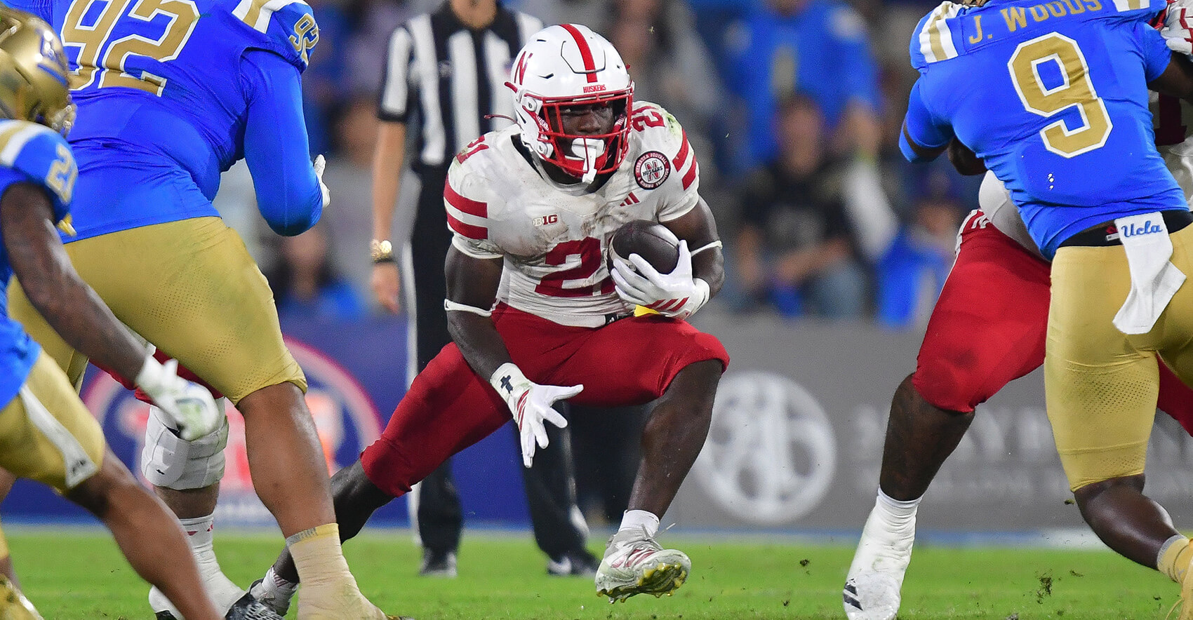 Nov 8, 2025; Pasadena, California, USA; Nebraska Cornhuskers running back Emmett Johnson (21) runs the ball against the UCLA Bruins during the second half at the Rose Bowl. Mandatory Credit: Gary A. Vasquez-Imagn Images
