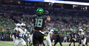 Dec 7, 2024; Indianapolis, IN, USA; Oregon Ducks tight end Kenyon Sadiq (18) catches a touchdown during the first quarter against the Penn State Nittany Lions in the 2024 Big Ten Championship game at Lucas Oil Stadium. Mandatory Credit: Jordan Prather-Imagn Images