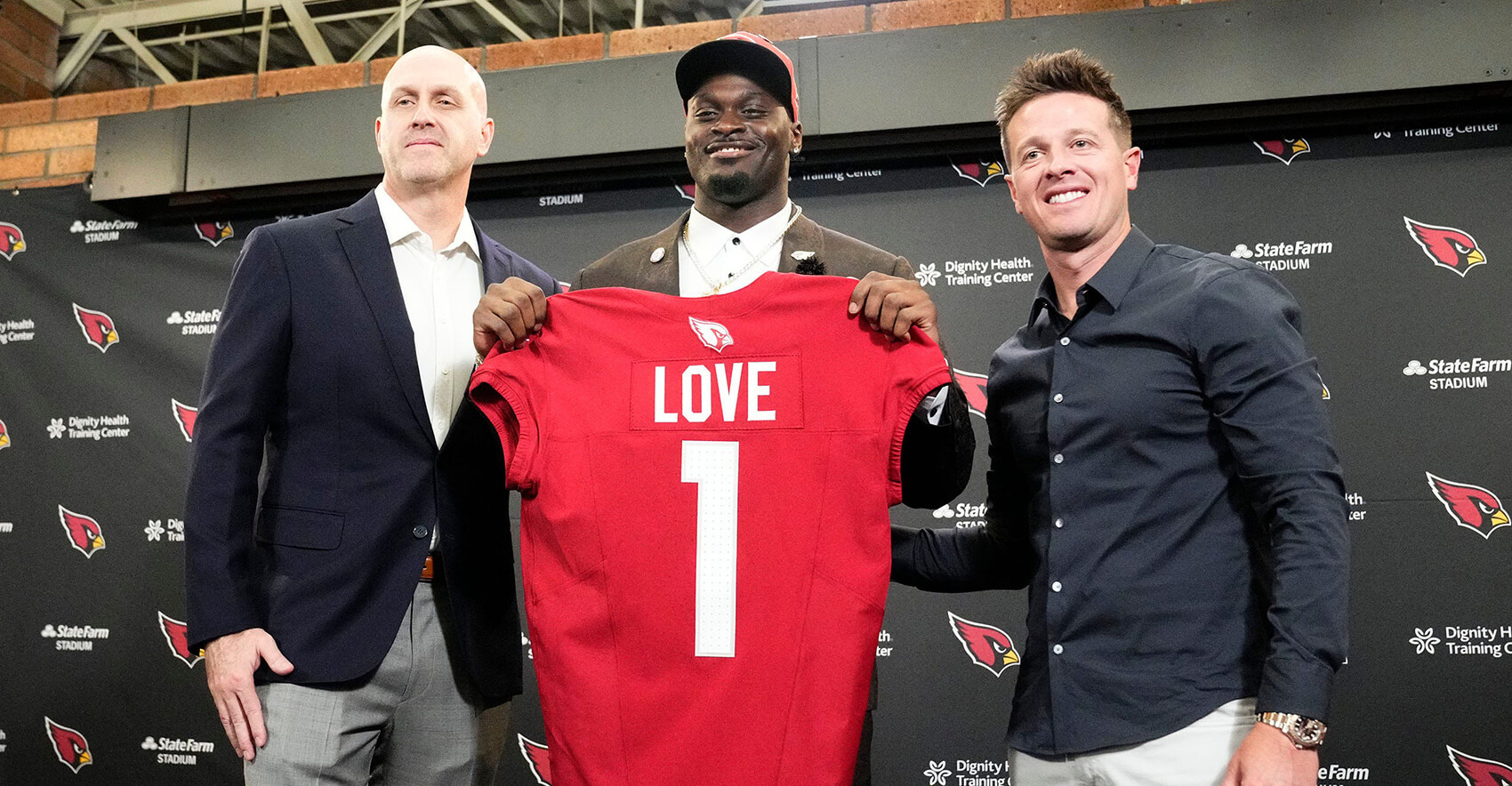 Arizona Cardinals general manager Monti Ossenfort and head coach Mike LaFleur (right) introduce their first-round draft pick†running back Jeremiyah Love†during a news conference at the Cardinals Dignity Health training facility on April 24, 2026, in Tempe, Ariz.