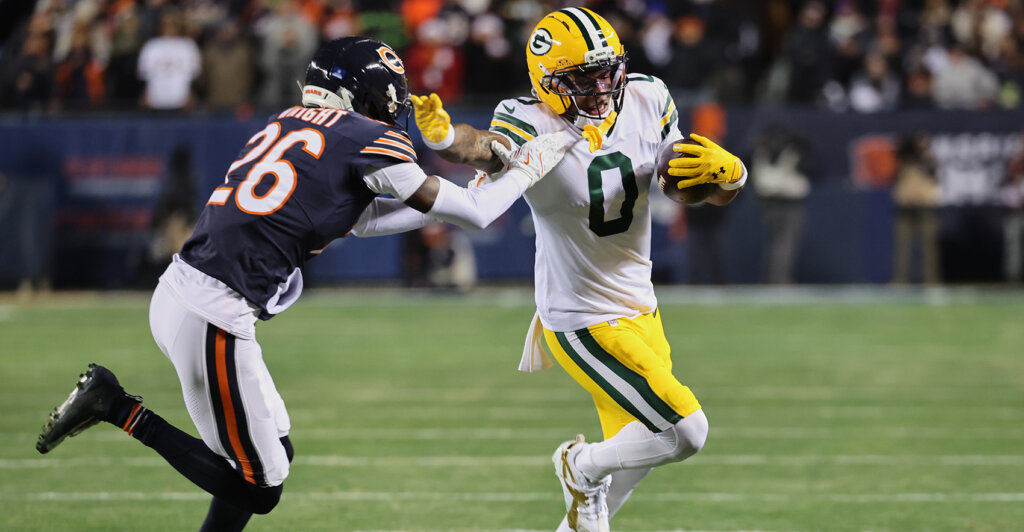 Dec 20, 2025; Chicago, Illinois, USA; Green Bay Packers wide receiver Matthew Golden (0) runs with the ball against Chicago Bears cornerback Nahshon Wright (26) during the first quarter at Soldier Field. Mandatory Credit: Mike Dinovo-Imagn Images