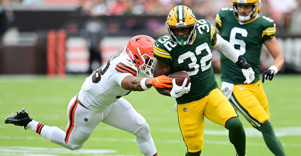 Aug 10, 2024; Cleveland, Ohio, USA; Green Bay Packers running back MarShawn Lloyd (32) runs with the ball as Cleveland Browns linebacker Caleb Johnson (48) defends during the second half at Cleveland Browns Stadium. Mandatory Credit: Ken Blaze-USA TODAY Sports