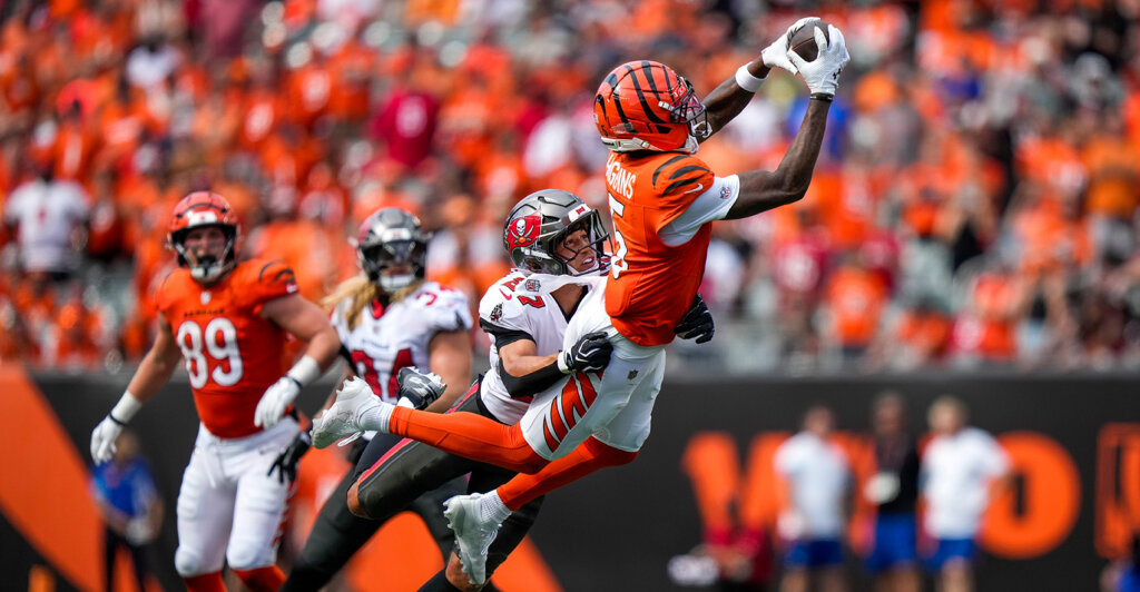 Cincinnati Bengals wide receiver Tee Higgins (5) makes a leaping catch over Tampa Bay Buccaneers cornerback Zyon McCollum (27) in the fourth quarter of the NFL Week 1 game between the Cincinnati Bengals and the Tampa Bay Buccaneers at Paycor Stadium in Cincinnati on Sunday, Sept. 13, 2026.