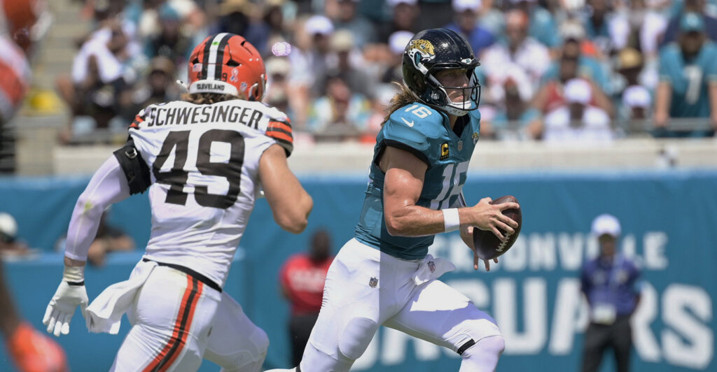 Sep 13, 2026; Jacksonville, Florida, USA;  Jacksonville Jaguars quarterback Trevor Lawrence (16) runs the ball against Cleveland Browns linebacker Carson Schwesinger (49) in the second quarter at EverBank Stadium.  Mandatory Credit: Melina Myers-Imagn Images