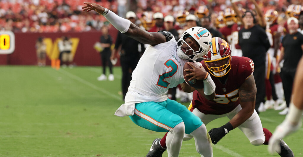 Aug 14, 2026; Landover, Maryland, USA; Miami Dolphins quarterback Malik Willis (2) is horse collar tackled by Washington Commanders defensive tackle Byron Cowart (55) during the first half at Northwest Stadium. Mandatory Credit: Geoff Burke-Imagn Images