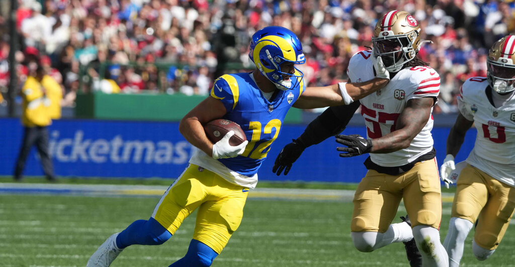 Sep 11, 2026; Melbourne, Victoria, Australia; Los Angeles Rams wide receiver Puka Nacua (12) carries the ball against San Francisco 49ers linebacker Dre Greenlaw (57) during the 2026 NFL Melbourne Game at Melbourne Cricket Ground. Mandatory Credit: Kirby Lee-Imagn Images