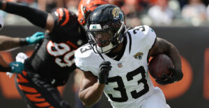 Oct 4, 2026; Cincinnati, Ohio, USA; Jacksonville Jaguars running back Bhayshul Tuten (33) runs with the ball during the first quarter against the Cincinnati Bengals at Paycor Stadium. Mandatory Credit: Joseph Maiorana-Imagn Images