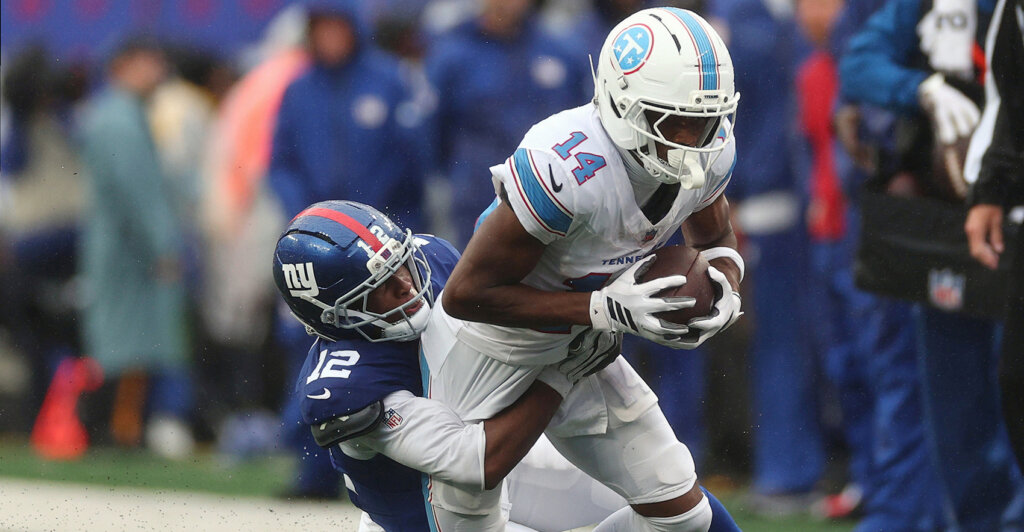 Sep 27, 2026; East Rutherford, New Jersey, USA; New York Giants cornerback Colton Hood (12) tackles Tennessee Titans wide receiver Carnell Tate (14) during the fourth quarter at MetLife Stadium. Mandatory Credit: Vincent Carchietta-Imagn Images