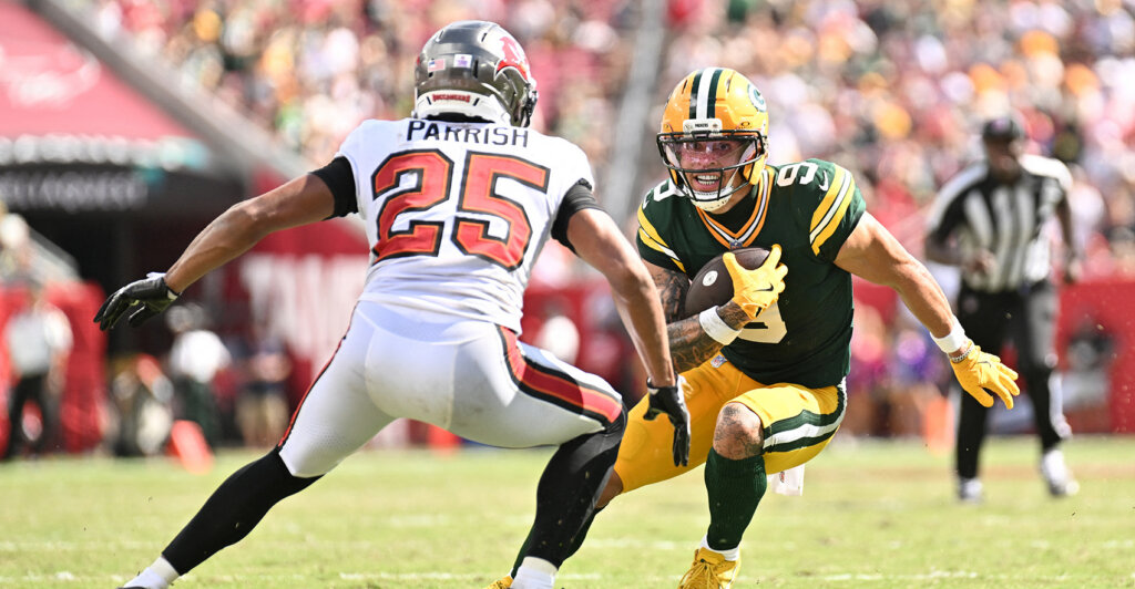 Oct 4, 2026; Tampa, Florida, USA; Green Bay Packers wide receiver Christian Watson (9) attempts to elude Tampa Bay Buccaneers cornerback Jacob Parrish (25) at Raymond James Stadium. Mandatory Credit: Jonathan Dyer-Imagn Images